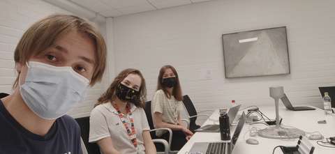 Selfie toimistolla, kuvassa kesätyöntekijät neuvottelupöydän äärellä