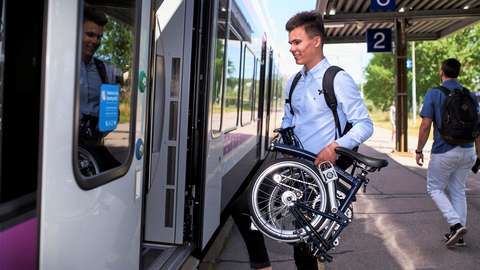 A man in the train station with his bike.