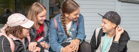 Pupils chatting in the school yard.