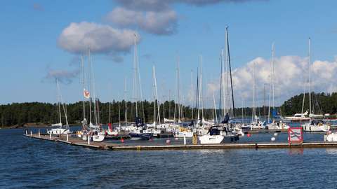 Sailboats at a marina in Suvisaaristo, photographed from the sea.