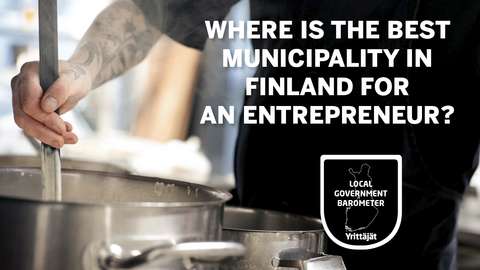 A person's hand stirring a cooking pot.