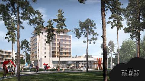 Vaaleasävyinen kerrostalorakennus, etualalla piha-aluetta.