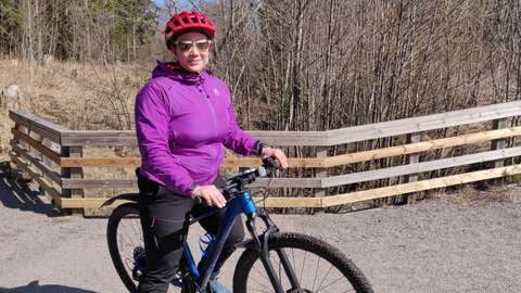 A woman on a bicycle.