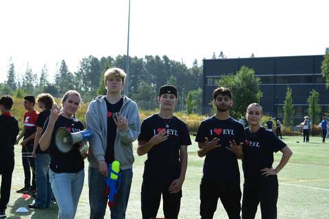 Viisi tutoria poseeraa kameralla kädessään megafoni ja vesipyssyjä.