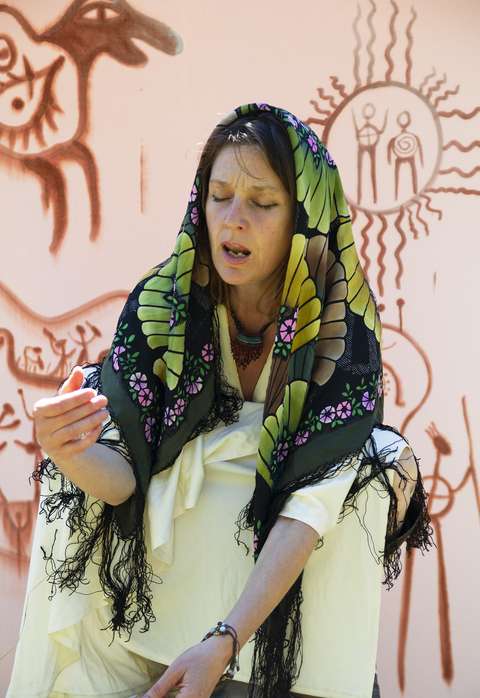 Shadow artist Elviira Davidow exorcizes in colorful clothing.