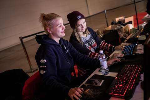 Two women playing computer games.