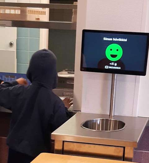 A child at the school cafeteria serving line.