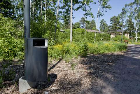 Litter bin, sand way and forest.