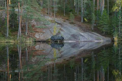 Lampi, jonka rannalla silokallio ja metsää.