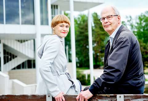 Tuuli Aaltio and Esko Uotila are smiling and looking at the camera. In the background, we can see the Espoo Cultural Centre in Tapiola.
