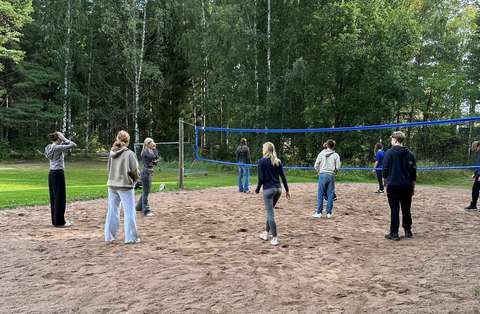 opiskelijat pelaavat lentopalloa Vasikkasaaressa