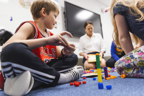 The children practice counting with different-colored plastic buttons.