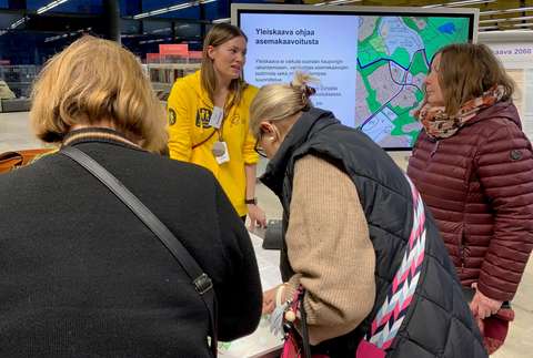 En stadsanställd diskuterar planen med invånarna under evenemanget.