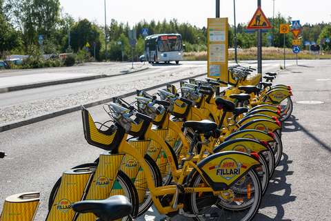 Yellow city bikes on a street in Espoo.