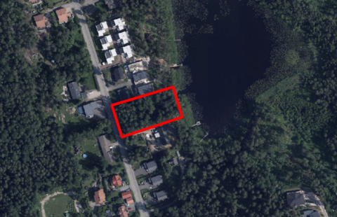 Järven rannalla sijaitsevan alueen ympärillä on pientaloja.