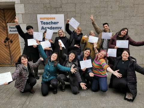 Opettajat iloitsevat diplomit kädessä.