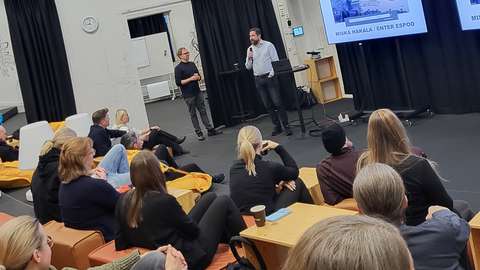 People sitting and listening speeches at Mordor venua in A Grid.