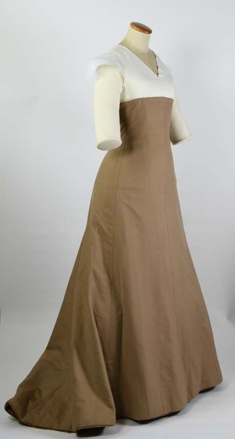 Vaatetuella ruskea vanha pitkämekko.