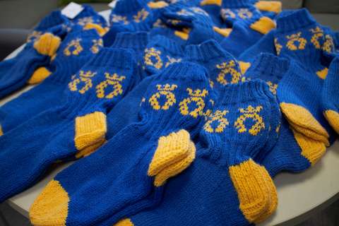 Blue and yellow woollen socks with the City of Espoo logo.