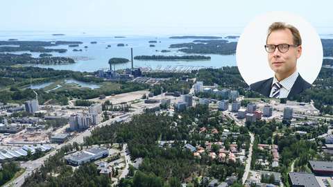 Aerial view showing high rise buildings, trees, roads and sea. The aerial photo features a round-shaped portrait of a man.