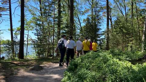 The photo shows a group of people walking in the archipelago.