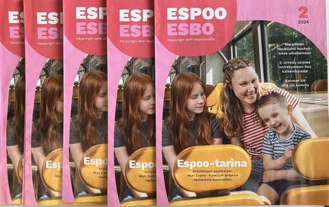A woman and two children on the cover of Espoo magazine.