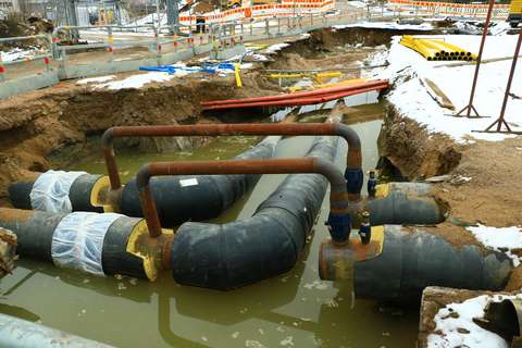  Fjärrvärmerör i diket och grönaktigt vatten.