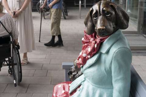 A sculpture that looks like a mix of dog and human.