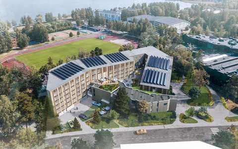 The image shows a new building. In front of it is a lower building, the original Urdsgjallar building.