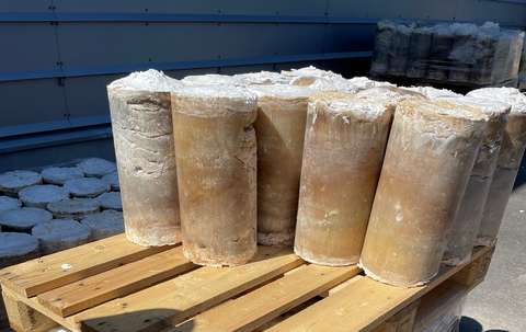 Brown, cylindrical objects on a wooden pallet.