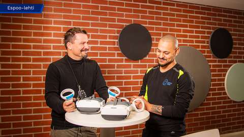 Ville Kaisla and Enea Mane are examining objects placed on the table.