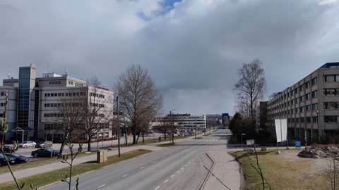 A photograph showing a street lined with office buildings.
