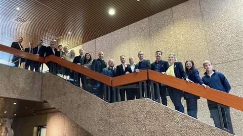 En grupp människor står på en trappa för att ta ett foto.