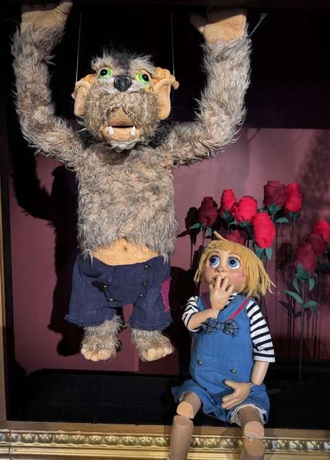 The puppets of the play Beaty and the Beast sitting on the stage.