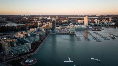 In the foreground, there is the sea in the background, and on the left, a few high-rise buildings and other buildings.