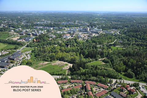 A summery aerial photograph shows an urban centre, areas with blocks of flats, detached houses and forest.