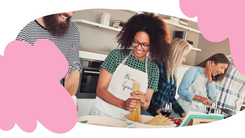 A group of adults cooking together.