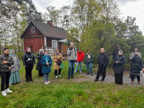 Exploratory walk participants at Kestikievarinpuisto Park listening to the history of the park.