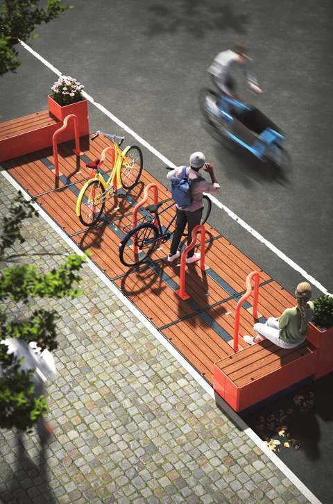 En stilren cykelparkering i orange nyanser med sittbänkar längs kanterna.