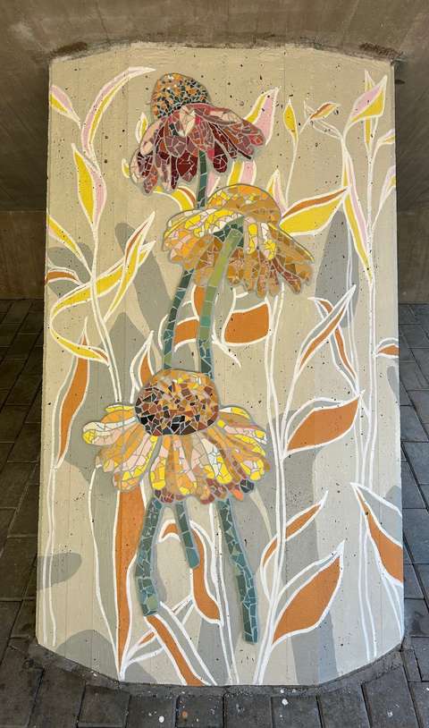 The mosaic artwork depicts coneflowers in shades of yellow and brown.