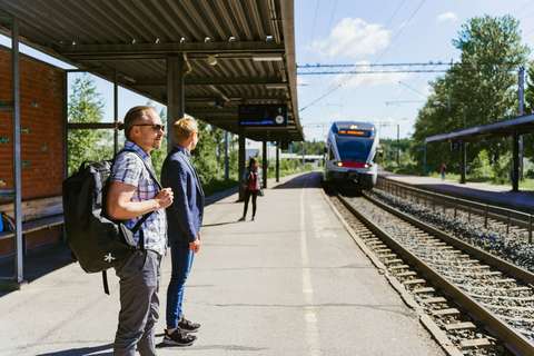 People waiting for a commuter train at Kera railway station.