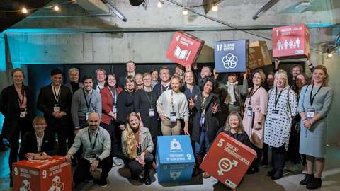 A large group of people with colorful cubes.