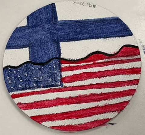 Käsityöteos, jossa Suomen ja USA:n liput kohtaavat.