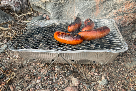Sausages cooking on a disposable barbecue