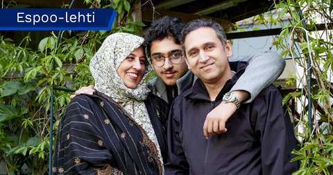 Asif and Zainab Naqvi and their teenage son are looking at the camera.
