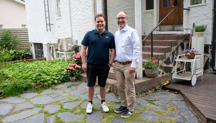 Aaro ja Jussi Tolvanen står leende framför ett ljust hus.