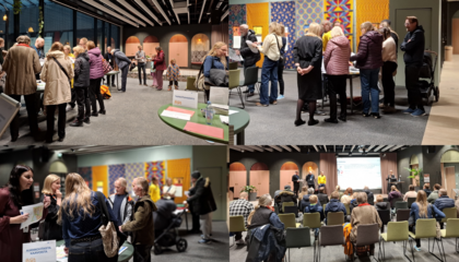 Deltagare diskuterar vid borden och lyssnar på en presentation.